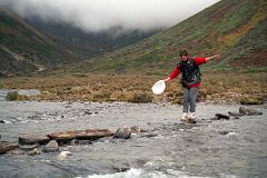 26 Shane Teeters Across The Rocks And Logs In The River Almost To Camp At Joksam Tibet.jpg